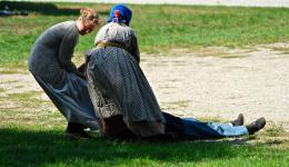 two women helping a soldier