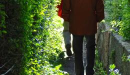 Two men walking in single file