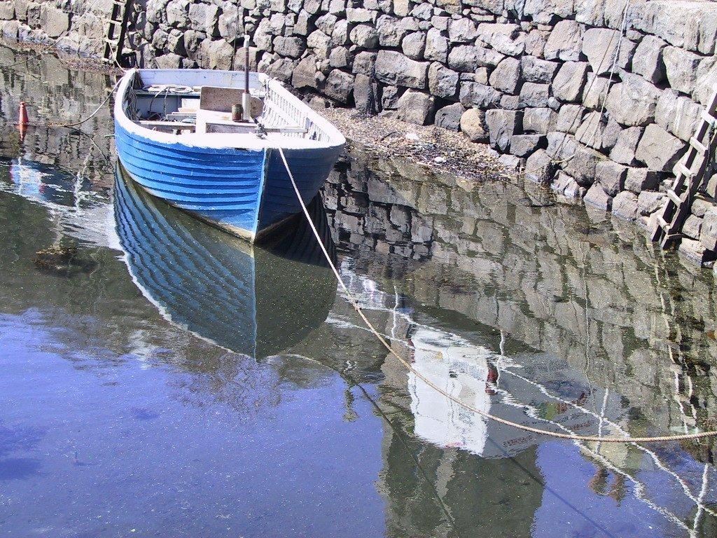 a moored blue boat